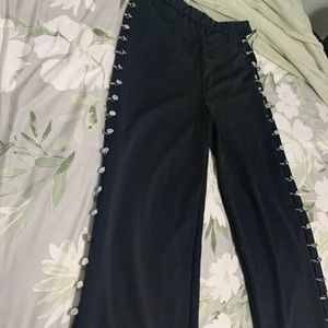 Black pants with silver hooks on the sides